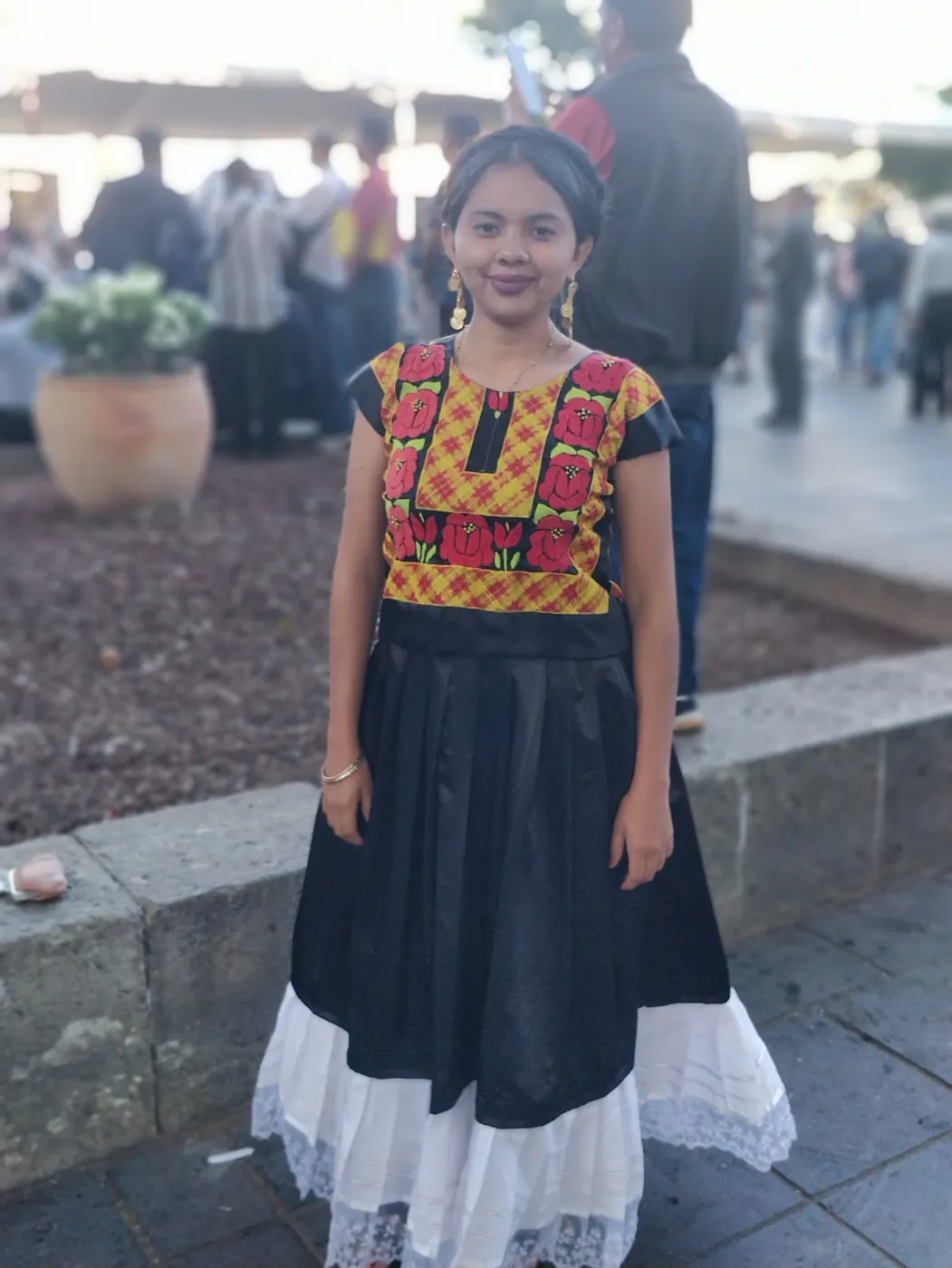 A girl in a traditional embroidered Mexican dress