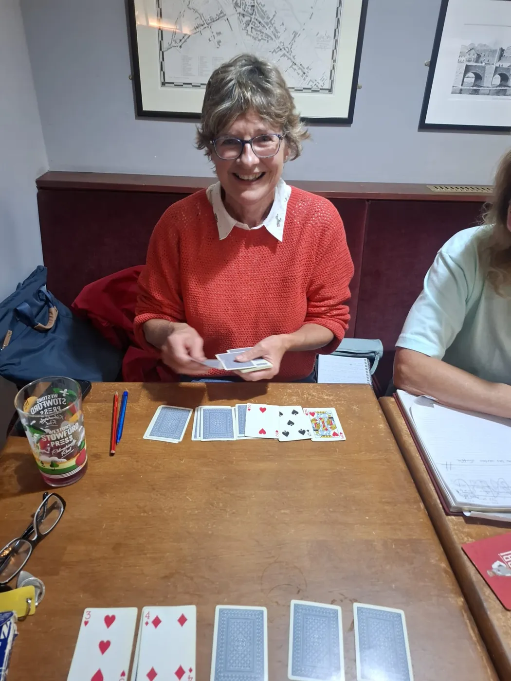 A smiling learner playing a card game during a Spanish lesson