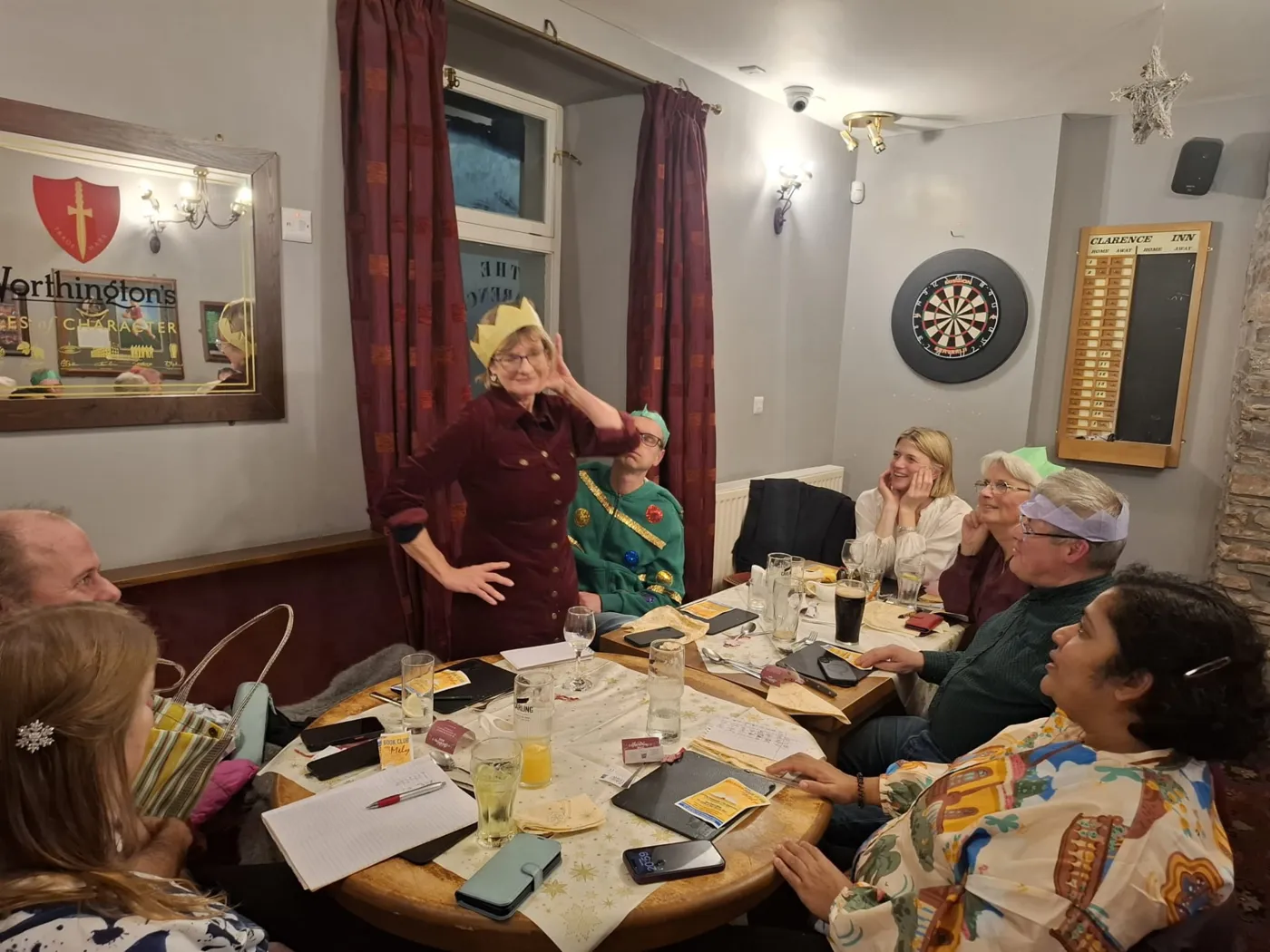 Spanish learners laughing together around a table at a social evening